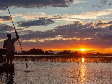 Two people on a mokoro in the Okavango Delta