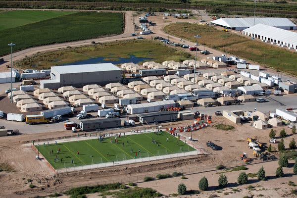 Sarah and the kids point at constellations in the night sky at Big Bend Ranch State Park, illuminated by the faint light of a headlamp.
