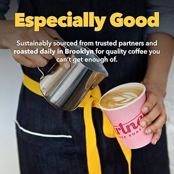 A close-up shot of coffee beans being poured into a grinder