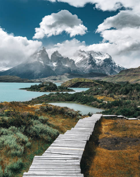 A professional photographer capturing the sunrise over the Torres del Paine peaks.
