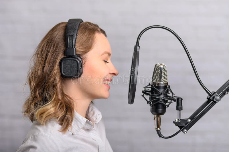 Photograph of a voice actor in a recording booth