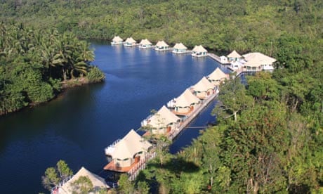 Javier filming the marine biologist examining damaged coral on a vibrant reef near Song Saa.