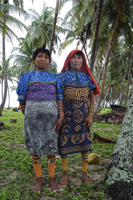 A group of volunteers cheering as hundreds of baby turtles crawl towards the ocean, highlighting the heartwarming experience of protecting the next generation of sea turtles.
