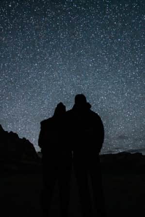A couple hiking towards a waterfall on a trail in Zion National Park, representing the last hike and the emotional farewell to the park.