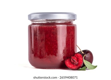 Cherry jam in a small jar on a wooden table