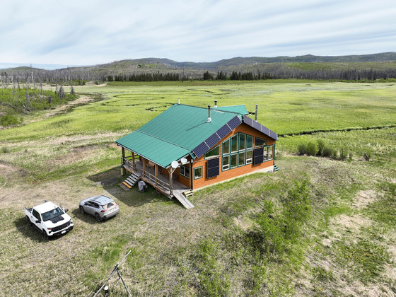 A ranch with beautiful mountains behind it.