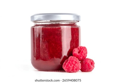 Raspberry jam in a small jar on a wooden table