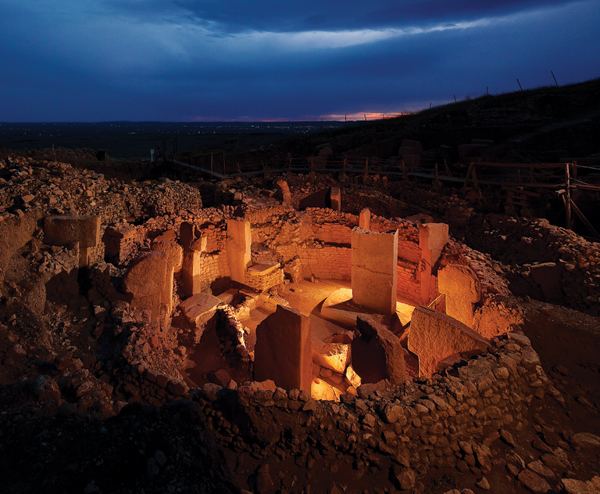 A T-shaped pillar at Göbekli Tepe, with intricate carvings of foxes, snakes, and other animals.