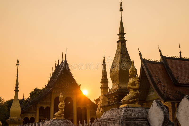 Monks collecting alms during the Sai Bat ceremony, their saffron robes vibrant against the soft morning light