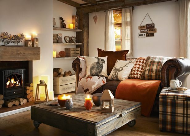 A sustainable farmhouse fall decor setup featuring natural elements, thrifted items, and repurposed glass jars is showcased on a wooden table.