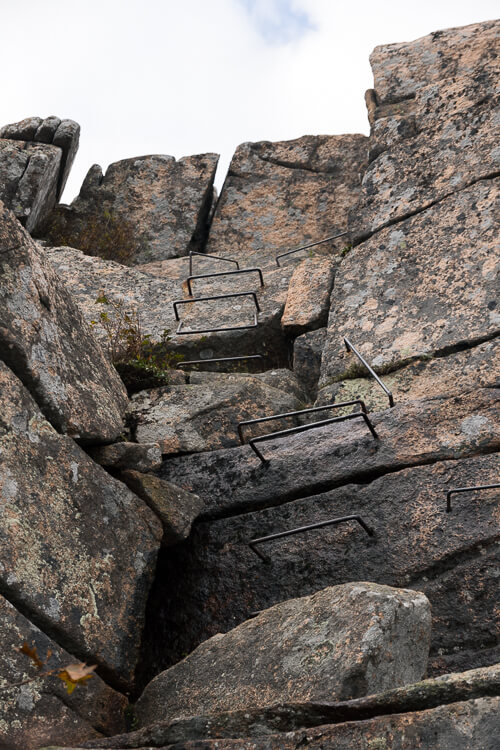 The Park Loop Road winds along the coast of Acadia National Park with Thunder Hole in the foreground