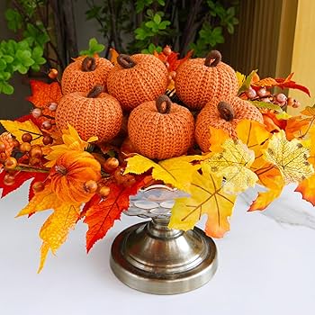 A close-up of an essential oil diffuser releasing a fragrant mist, surrounded by autumn leaves and spices