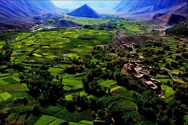 The Ait Bougmez Valley, showcasing terraced fields and mud-brick villages blending into the landscape