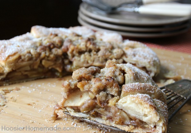 A partially assembled apple pie with a lattice crust