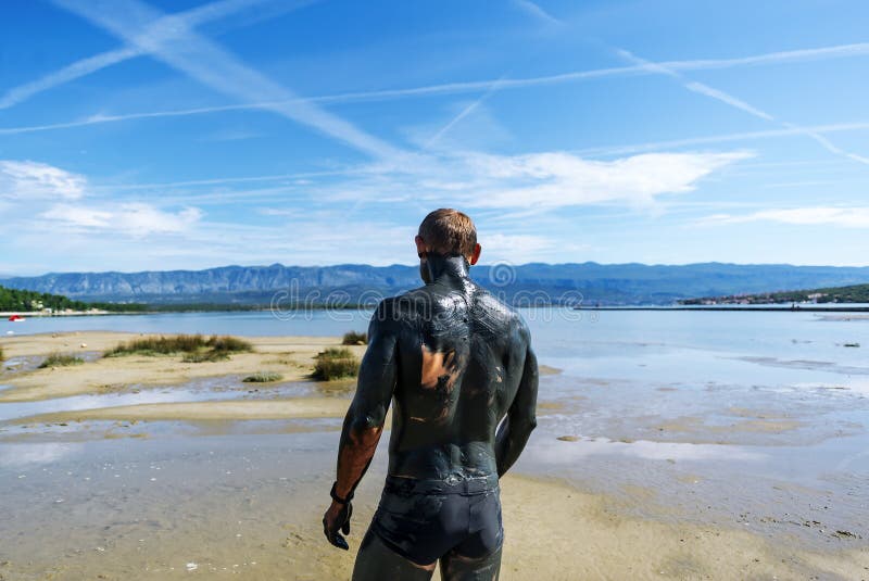 Close-up shots of the cracked, mineral-rich mud on the skin, conveying texture and the intense salt concentration.