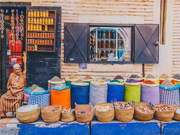 Artisan Ali Baba crafting leather babouches in his Marrakech workshop.