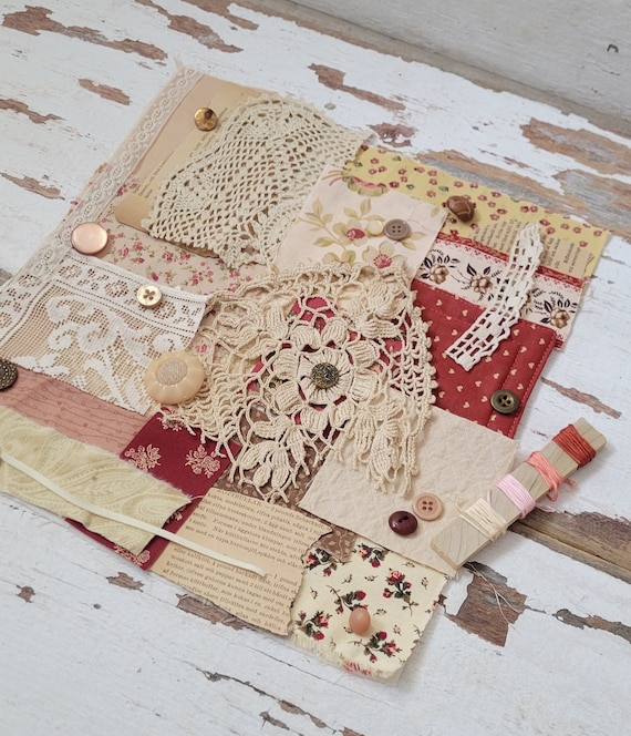 pile fabric scraps needles thread wooden table