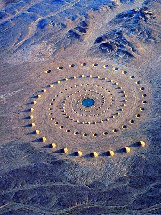 A group of people participating in a Berber weaving workshop in Morocco, guided by a local artisan