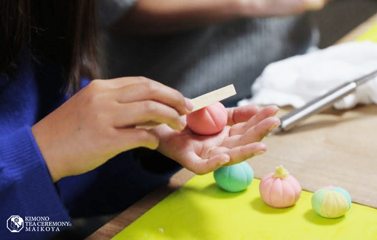 Hands delicately crafting wagashi, traditional Japanese sweets, showcasing the precision, artistry, and use of natural ingredients