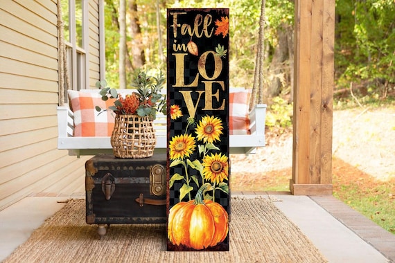 A cozy fall entryway with pumpkins, a blanket, and a lantern.