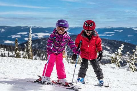 Kids learning to ski with an instructor