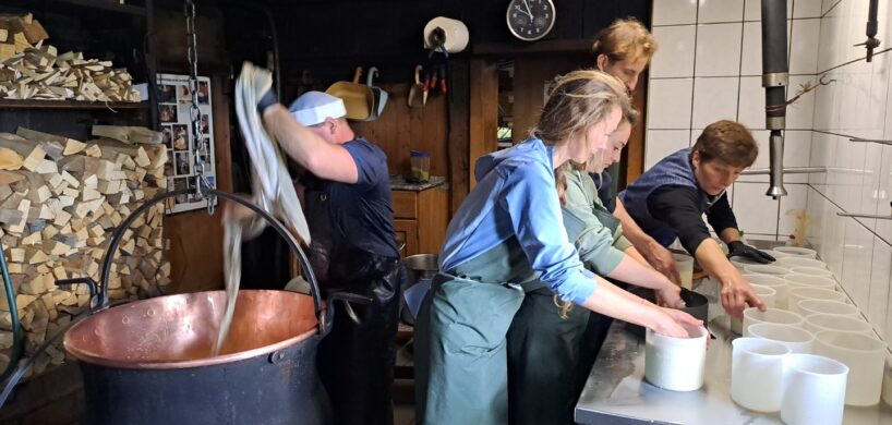 A helicopter flying over the Canadian Rockies, showcasing snow-capped peaks and turquoise lakes.