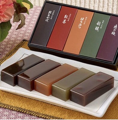 A selection of colorful and intricately designed wagashi arranged on a plate.