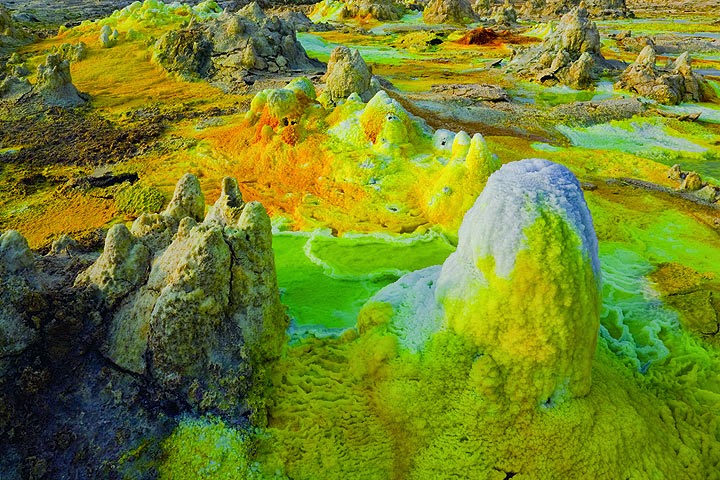 Aerial drone shot of the Dallol Volcano's vibrant, multi-colored pools, emphasizing the scale and alien-like landscape.