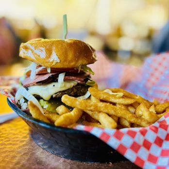 A motion shot of someone riding an e-bike along the Pa'rus Trail, with the Virgin River and the red rock canyon walls in the background. Captures the sense of speed and freedom.
