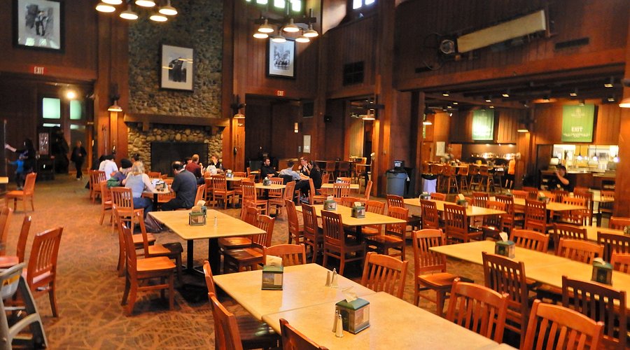 Mirror Lake reflects Half Dome at sunrise, bathed in golden light, creating a sense of tranquility and awe.