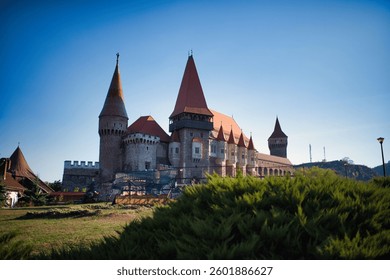 Corvin Castle in daylight, showcasing its Gothic architecture and imposing presence.