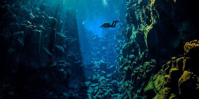Ice Diving - Wide shot of diver in Silfra Fissure