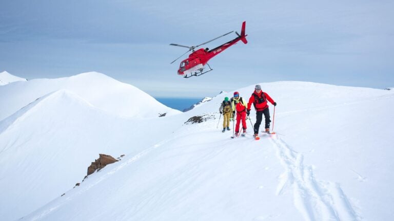 A heli-skier carving through fresh powder in Iceland