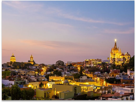 The courtyard pool area at Hotel Matilda with bougainvillea and a view of the city