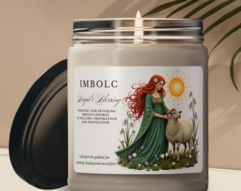 A collection of candle-making supplies laid out on a wooden table, including beeswax, dried herbs, mason jars, and silicone molds