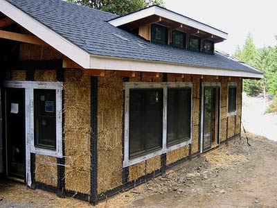 Installing sheep's wool insulation batts into wall cavities