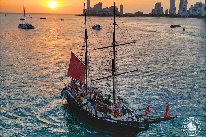 Sunset over Cartagena's walled city, golden light reflecting off the colorful buildings