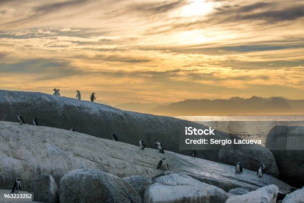 A scenic sunrise over a tropical beach, with longtail boats silhouetted against the colorful sky. The image captures the tranquil beauty of Sunrise Beach in Koh Lipe, Thailand.