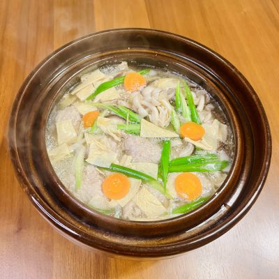 Travelers with snowshoes next to a traditional building.