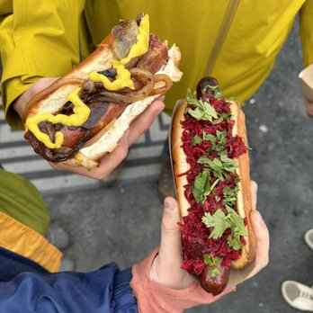 A ranger points out sea creatures in a tide pool to a group of visitors.