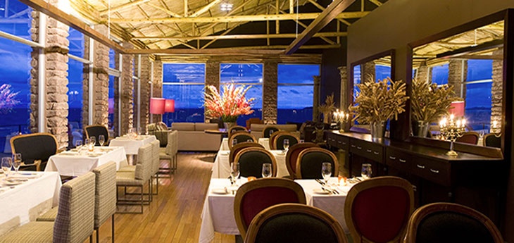Uros man sailing a small traditional reed boat on Lake Titicaca