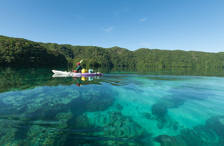 Kayaking through the Rock Islands Southern Lagoon in Palau, surrounded by turquoise waters and dramatic limestone formations