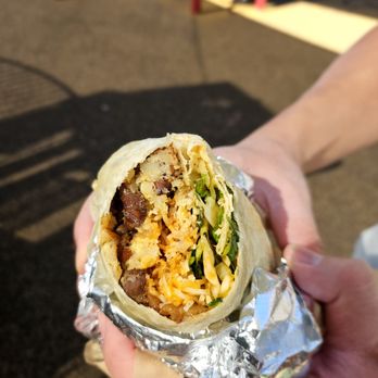 A close-up shot of a Korean short rib burrito from Kim Jong Grillin'. The focus is on the flavorful ingredients and the generous portion size. The image highlights the value for money and the deliciousness of this signature dish.