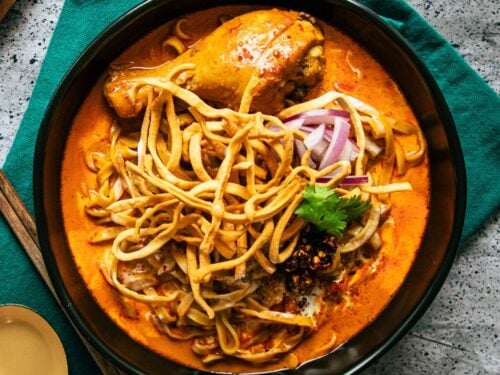 Visiting a local night market and trying Khao Soi, a traditional Thai dish.