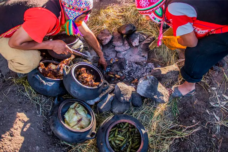 Local Quechua women weaving traditional textiles near Rainbow Mountain, showcasing the cultural richness of the region.