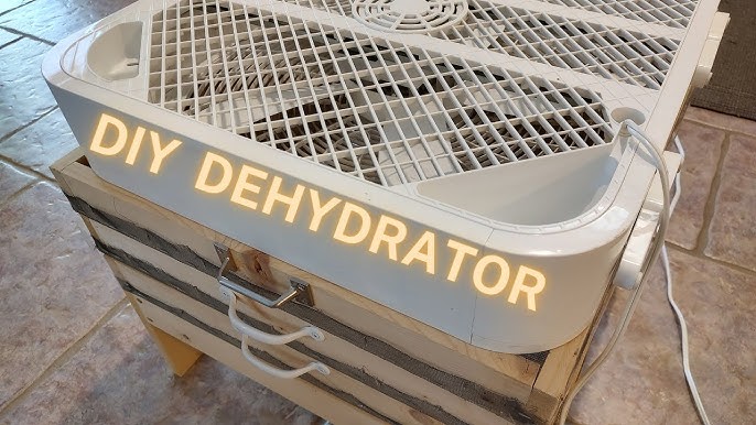 Applying black paint to the inside of the refrigerator that will be used for the solar food dehydrator