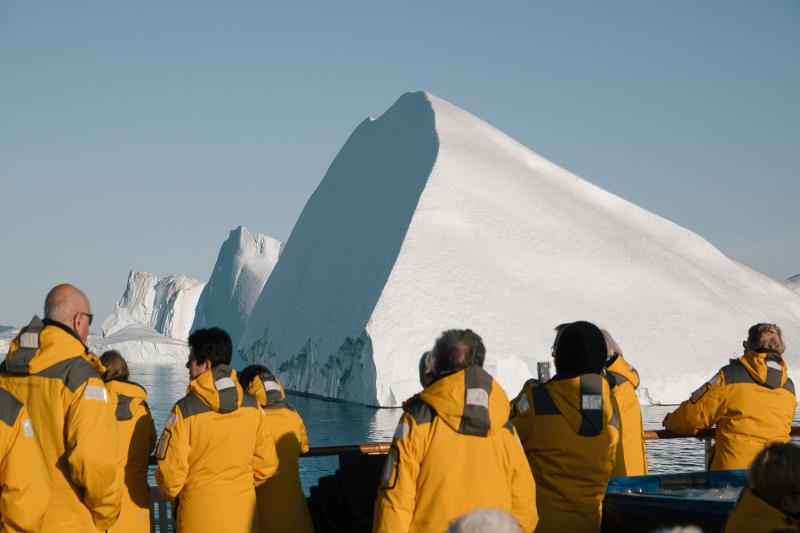 Portrait of Isabella Rodriguez, a local diver, standing with members of the Mayan community in front of a cenote.