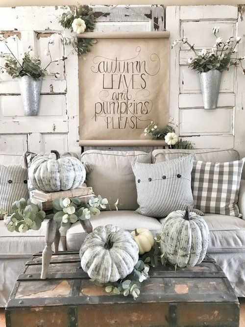A collection of vintage mason jars filled with dried flowers and autumn foliage. These jars showcase how thrifted finds can be used to create charming fall decor.
