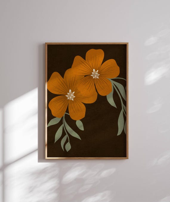 Vintage botanical prints from the 1920s and 1930s, framed in simple wooden frames, displayed on a bookshelf. Antique brass bookends hold a collection of novels and gardening books.