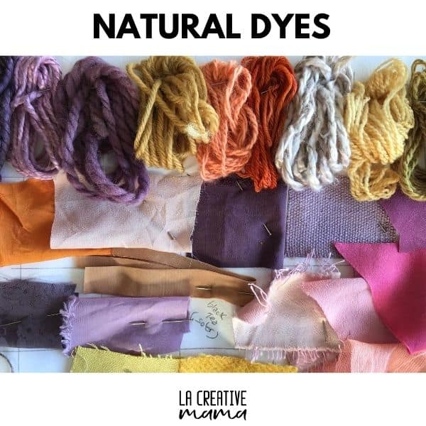 Finished naturally dyed linen napkins and cotton tea towels displayed on a wooden table in a rustic homestead kitchen.